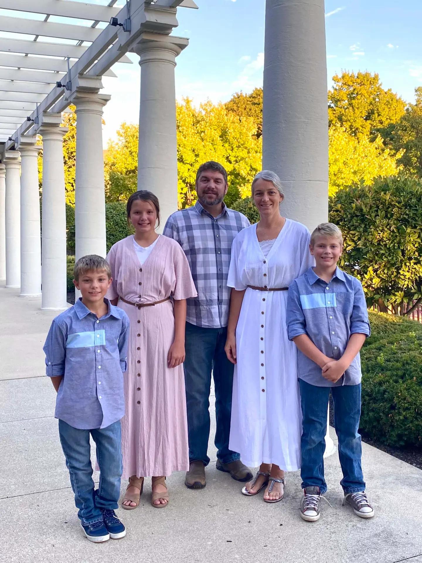 Jay and Trish Hochstetler family posing by white columns